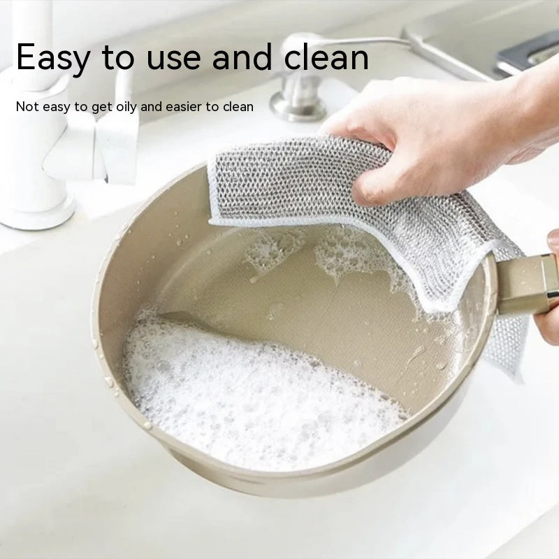 Reusable steel wire dishcloth chainmail mesh scrubbing a cast iron pan