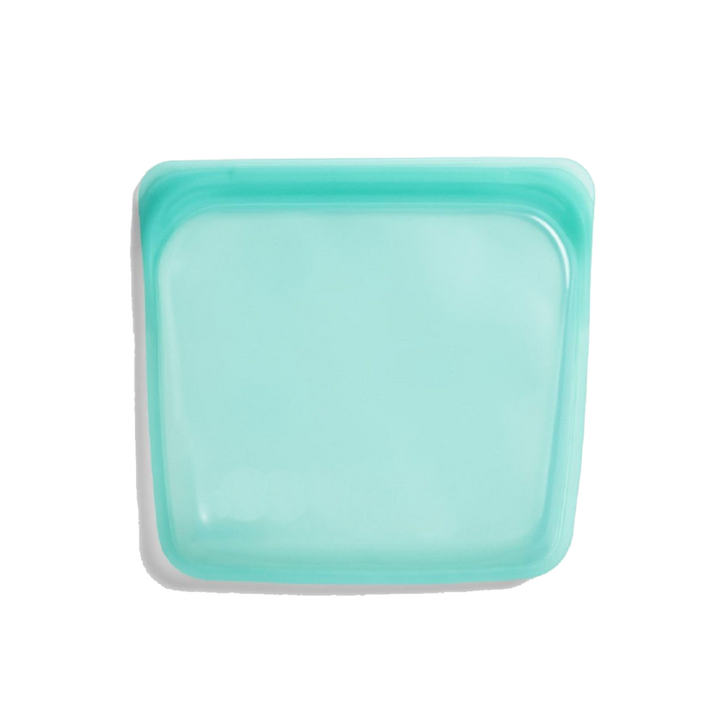 Reusable silicone food storage bag standing upright with leakproof seal